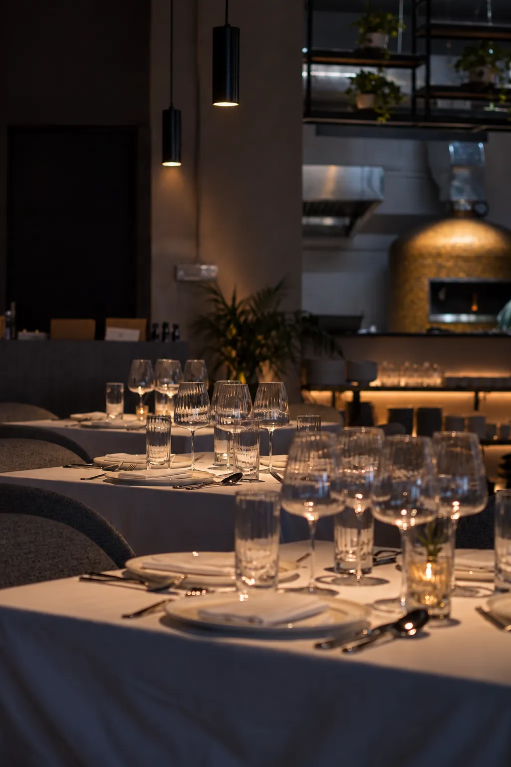The dining room with pendant lights and the open kitchen beyond