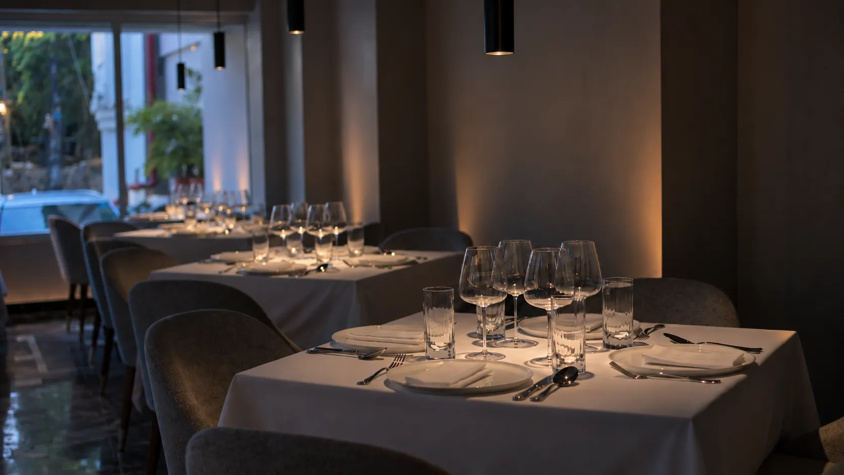 ALT's dining room at golden hour, tables laid with white linen
